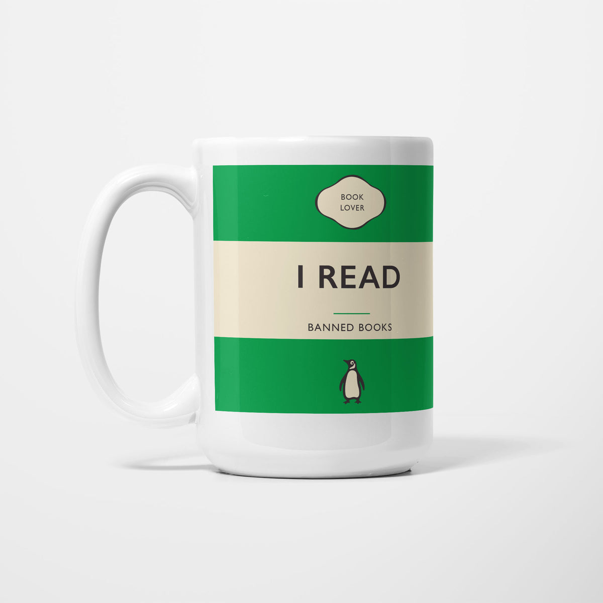 The 15oz I Read Banned Books mug, white ceramic printed as a vintage paperback jacket in green and cream, reading 'I Read' above 'Banned Books'