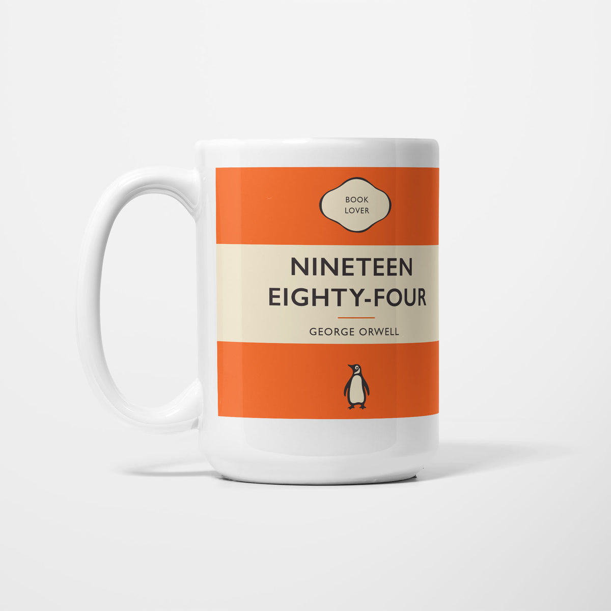 The 15oz 1984 mug, white ceramic printed as a vintage paperback jacket in orange and cream, reading 'Nineteen Eighty-Four' above George Orwell