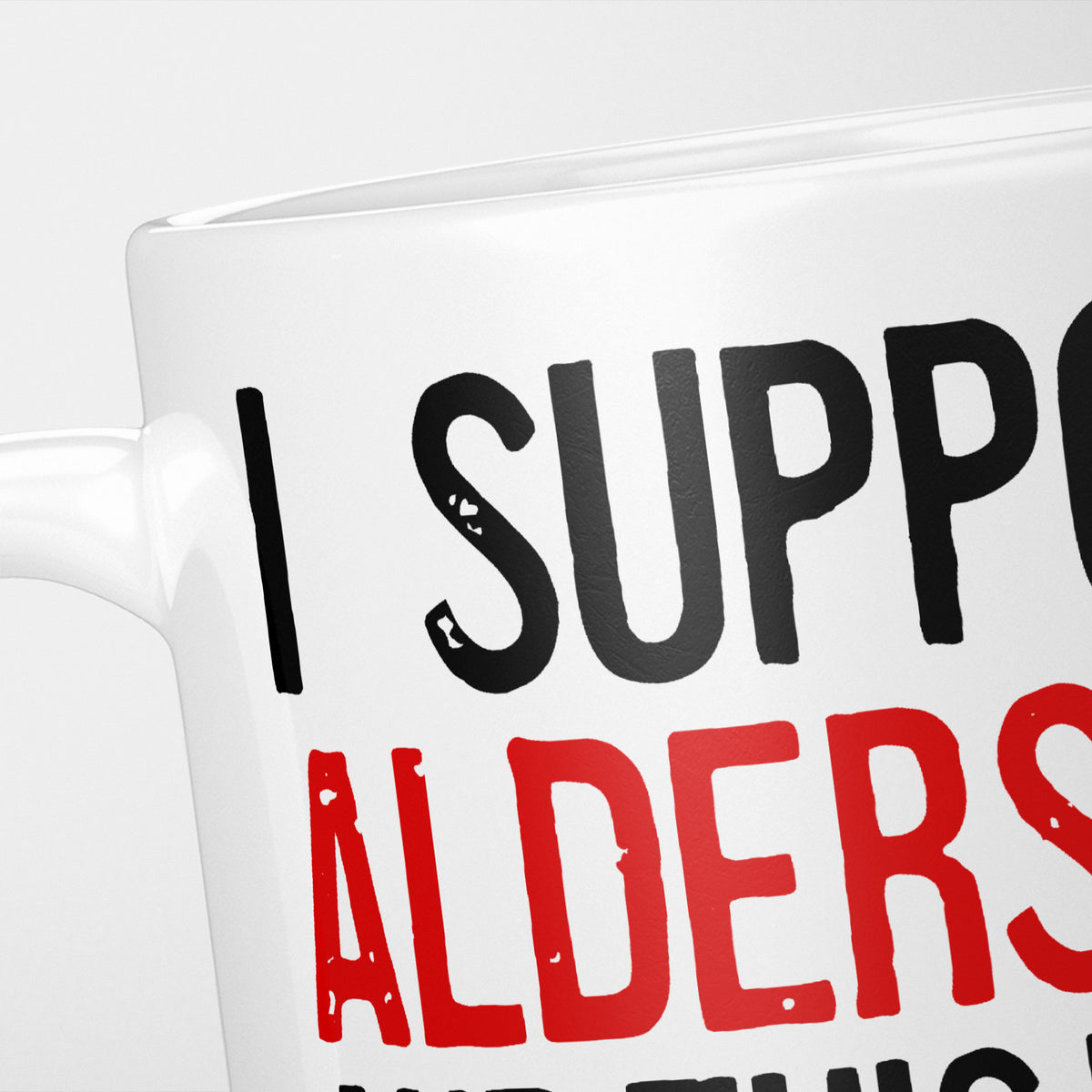 Close crop of the I Support Aldershot mug, 'I Support' in heavy black above the club name in red, running off the edge of the frame