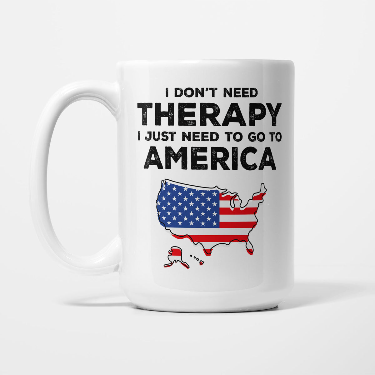 The 15oz I Need America mug, white ceramic in bold black type reading 'I don't need therapy, I just need to go to AMERICA', above an outline of America filled with its national flag