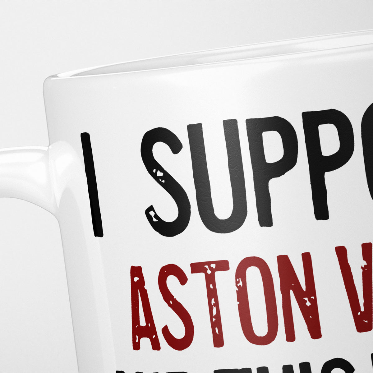 Close crop of the I Support Aston Villa mug, 'I Support' in heavy black above the club name in claret, running off the edge of the frame