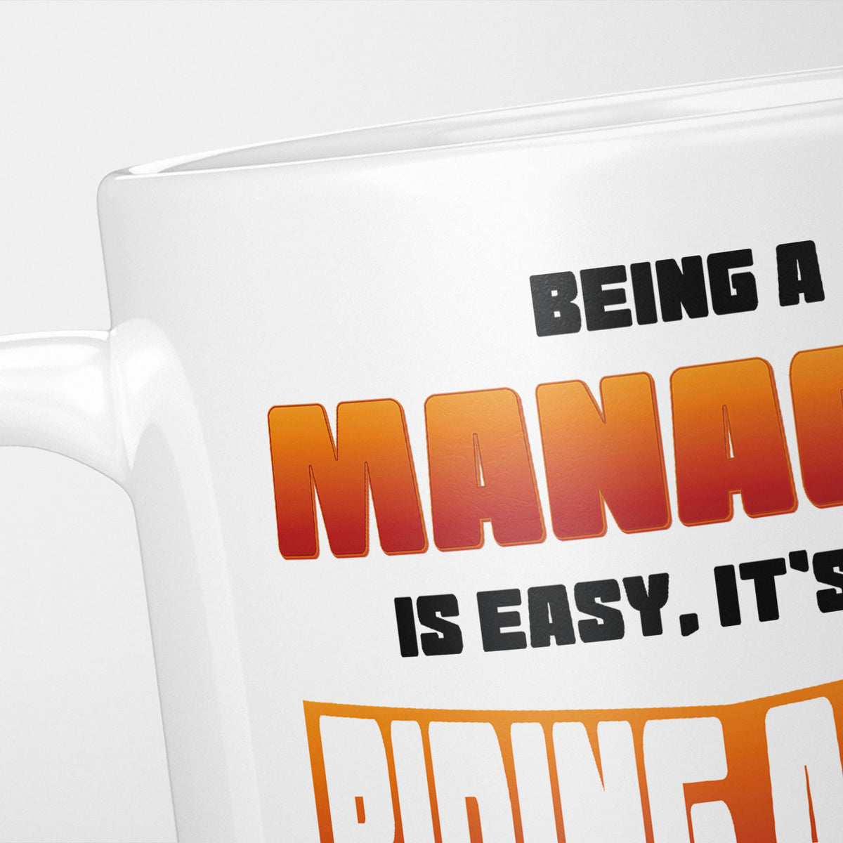 Close crop of the Being A Manager Is Easy mug, 'Being a MANAGER is easy. It's…' in orange and black