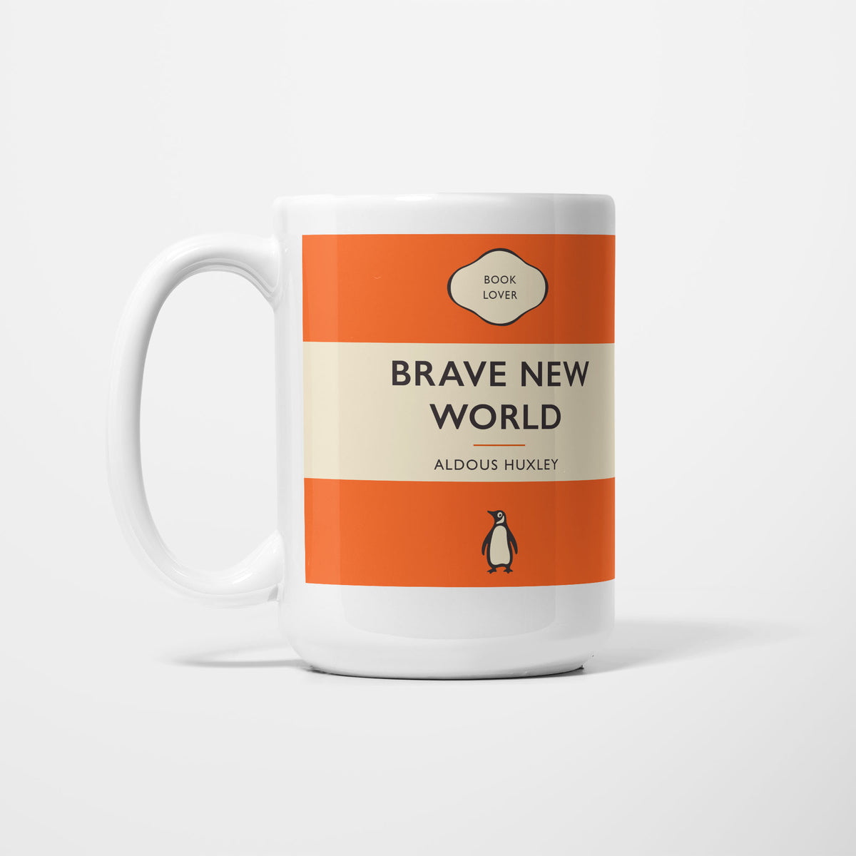 The 15oz Brave New World mug, white ceramic printed as a vintage paperback jacket in orange and cream, reading 'Brave New World' above Aldous Huxley