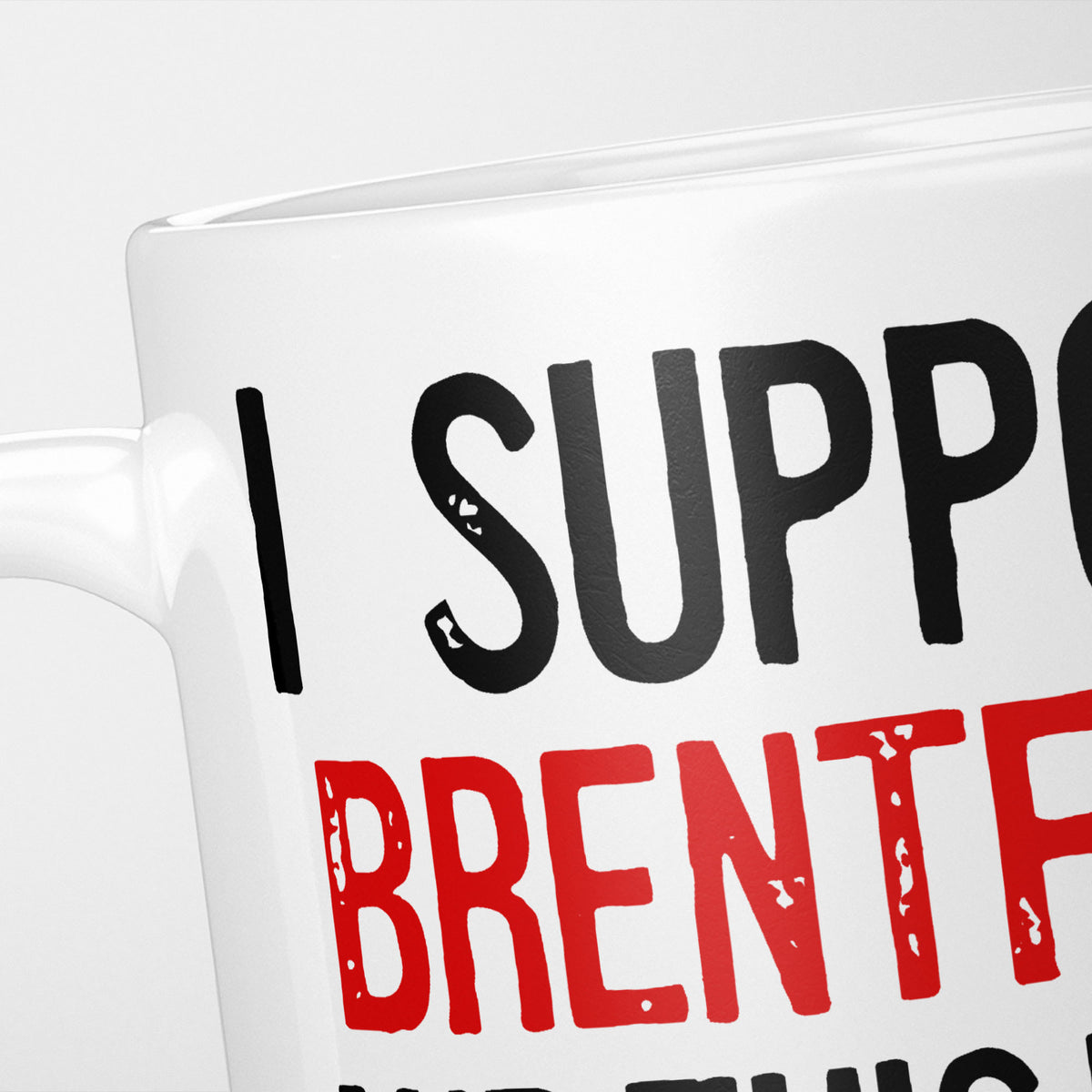 Close crop of the I Support Brentford mug, 'I Support' in heavy black above the club name in red, running off the edge of the frame