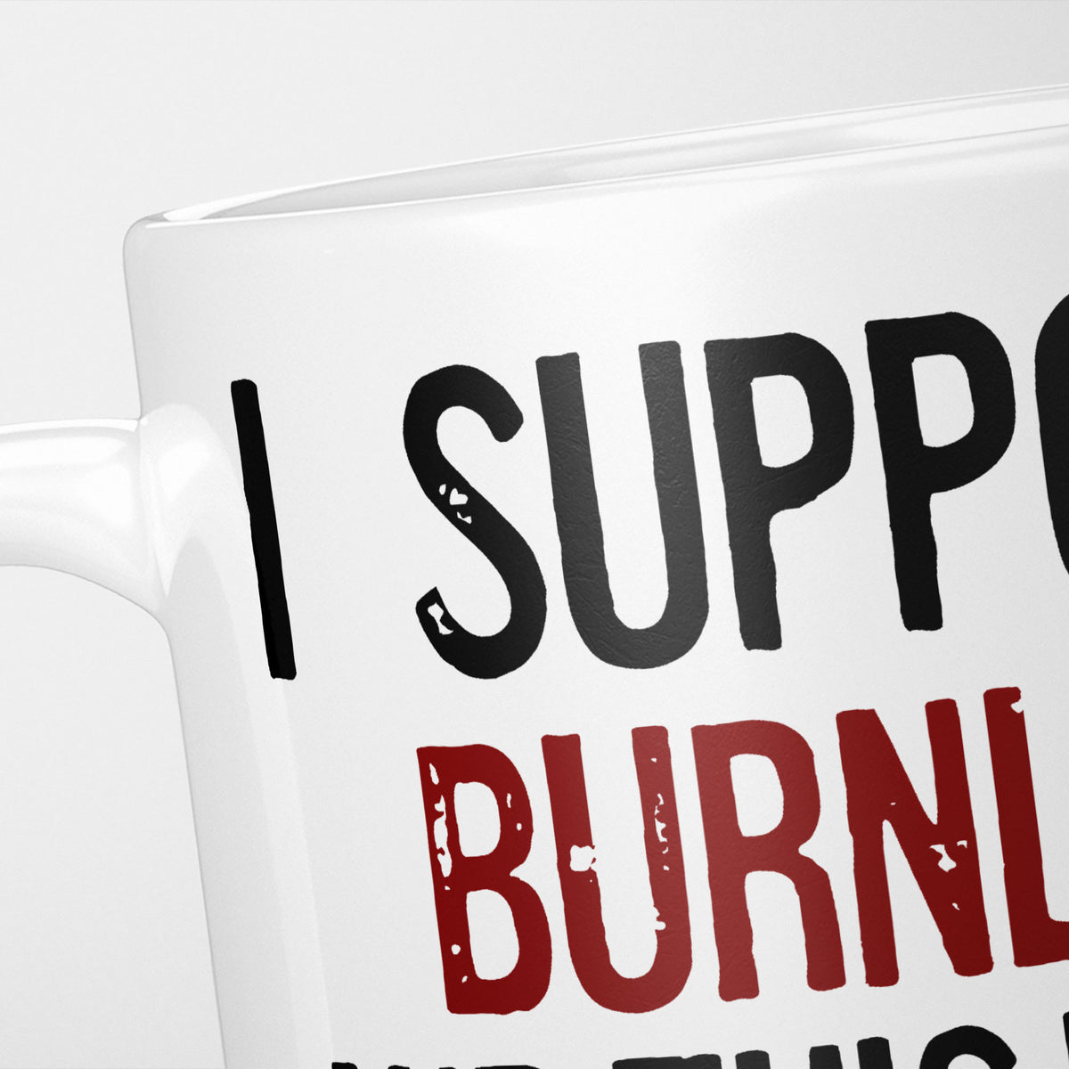 Close crop of the I Support Burnley mug, 'I Support' in heavy black above the club name in claret, running off the edge of the frame