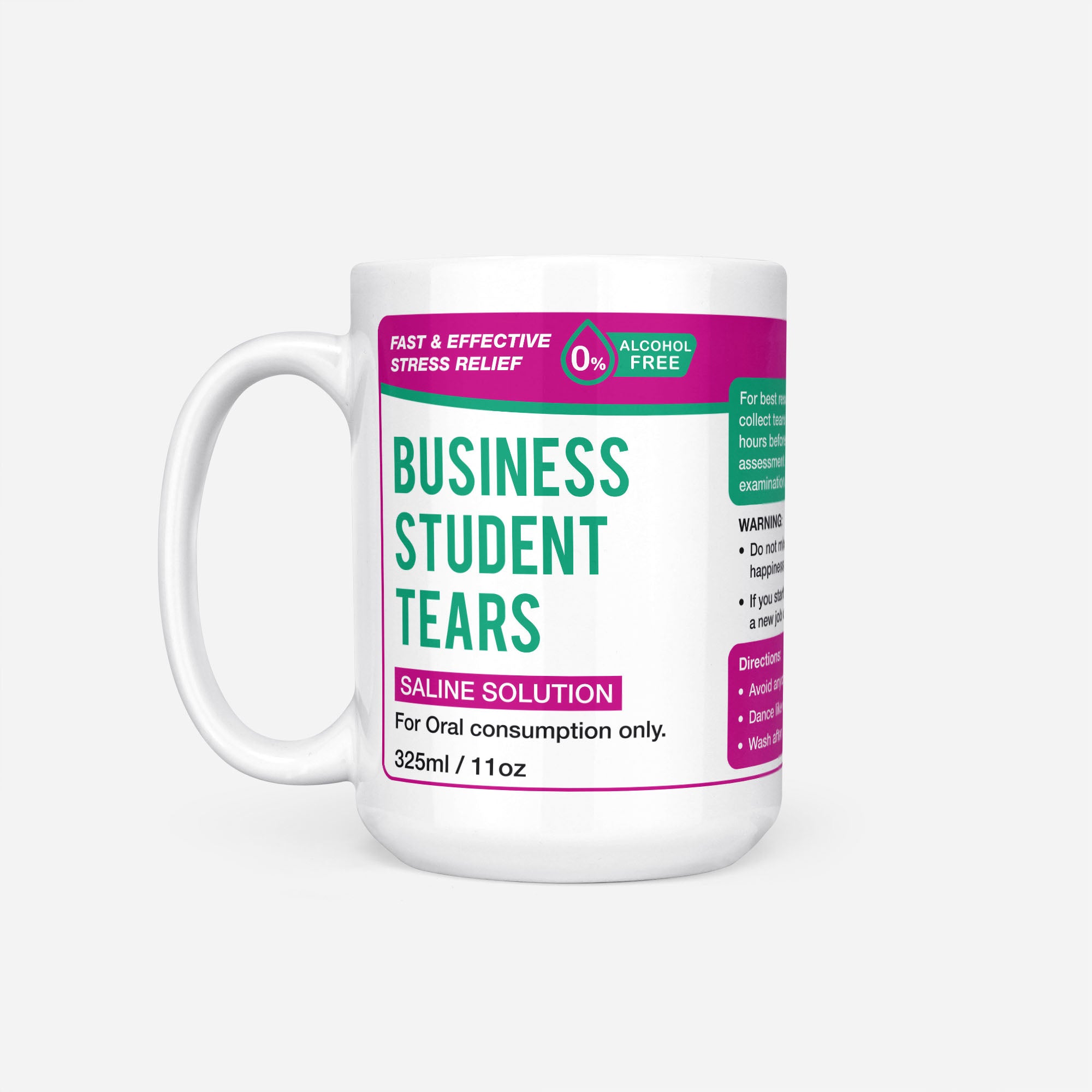 The 15oz Business Student Tears mug, white ceramic with a magenta pharmacy-style label reading 'Business Student Tears — Saline Solution, for oral consumption only'
