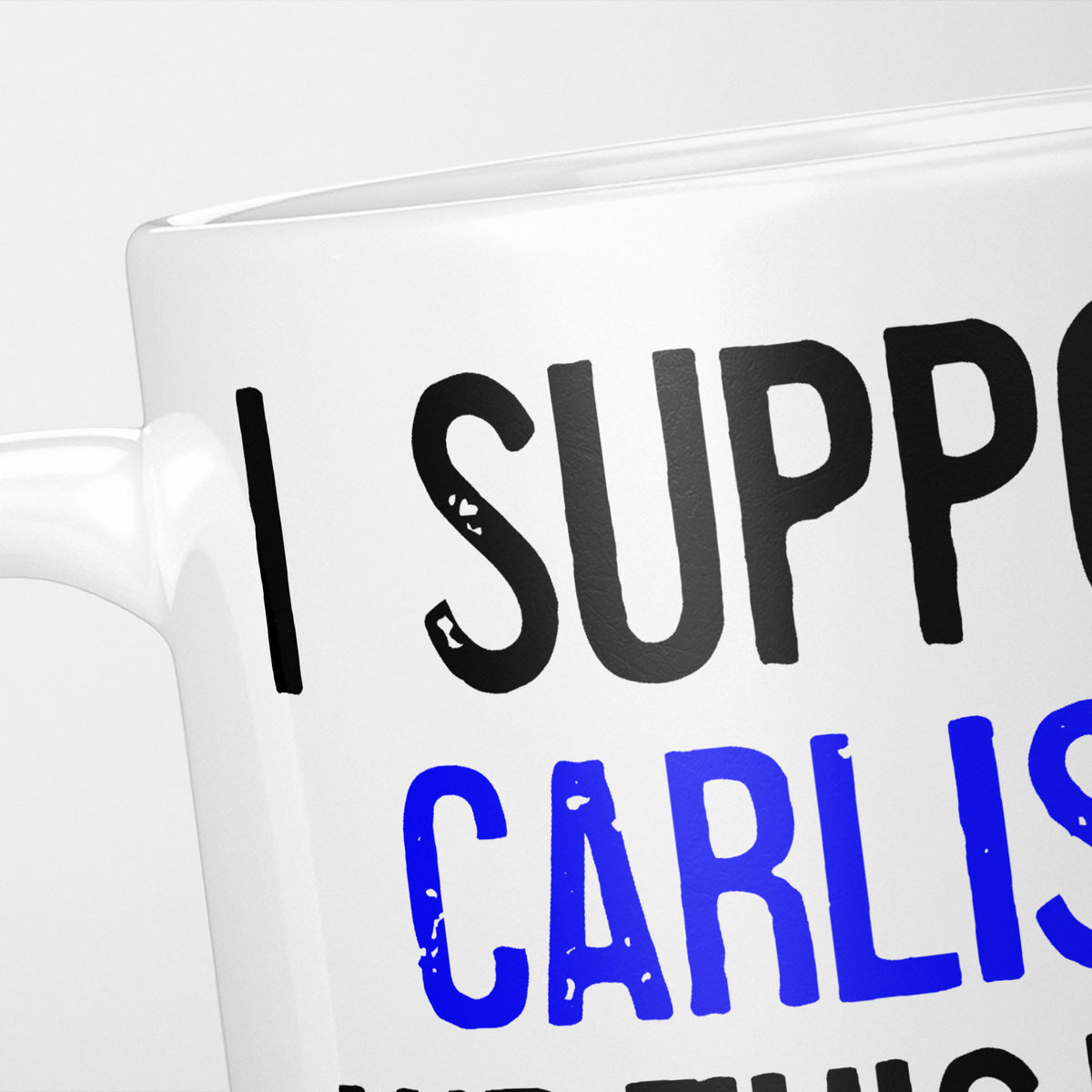 Close crop of the I Support Carlisle mug, 'I Support' in heavy black above the club name in blue, running off the edge of the frame