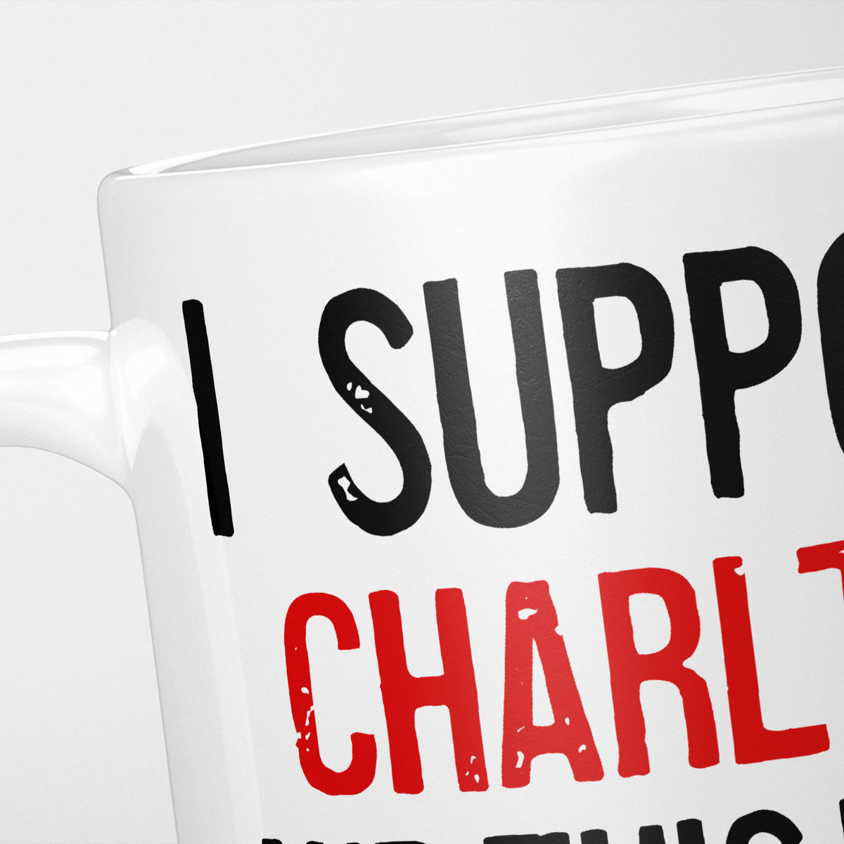 Close crop of the I Support Charlton mug, 'I Support' in heavy black above the club name in red, running off the edge of the frame
