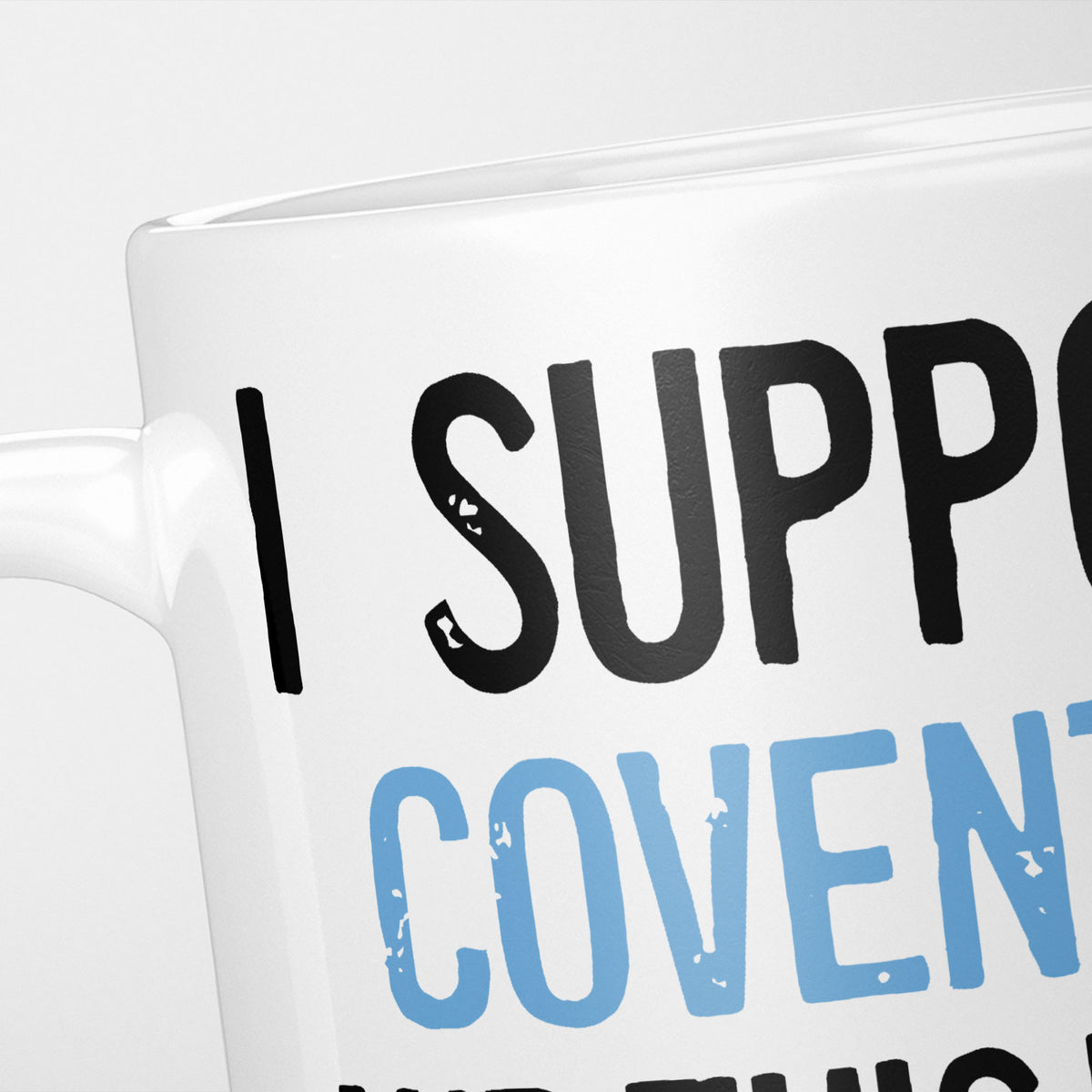 Close crop of the I Support Coventry mug, 'I Support' in heavy black above the club name in sky blue, running off the edge of the frame