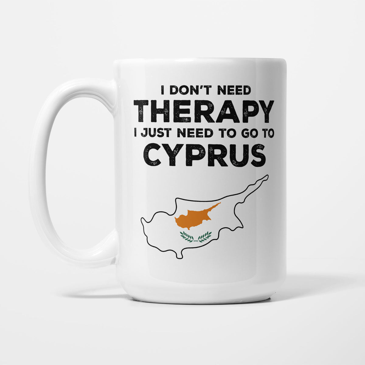 The 15oz I Need Cyprus mug, white ceramic in bold black type reading 'I don't need therapy, I just need to go to CYPRUS', above an outline of Cyprus filled with its national flag