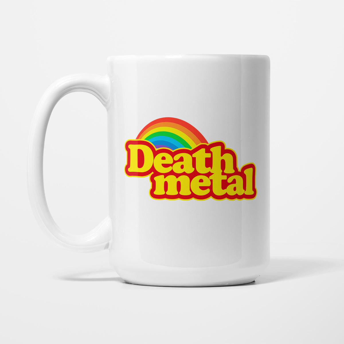 The 15oz Death Metal Rainbow mug, white ceramic with the words 'Death metal' in rounded red and yellow sweet-wrapper lettering beneath a bright rainbow arc