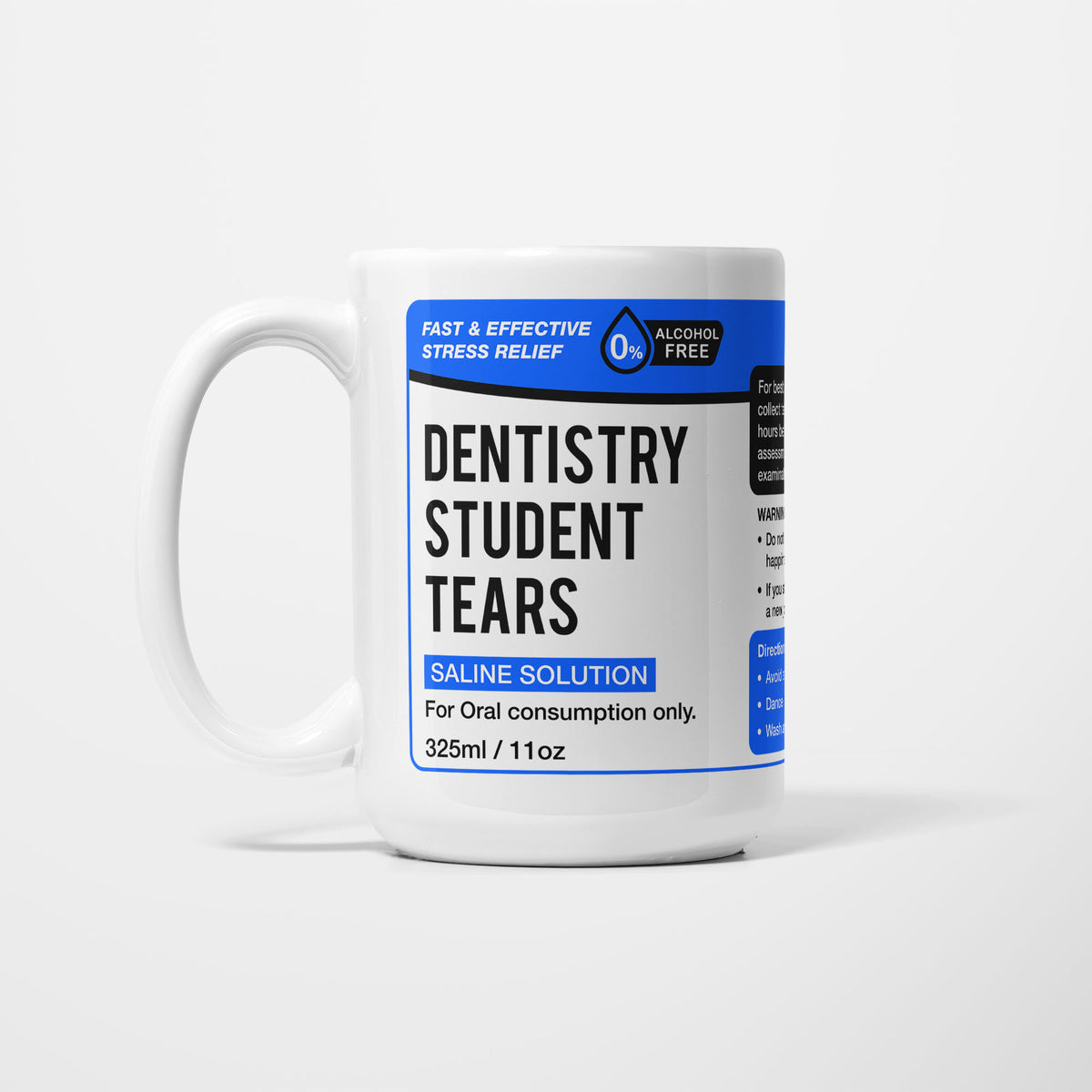 The 15oz Dentistry Student Tears mug, white ceramic with a blue pharmacy-style label reading 'Dentistry Student Tears — Saline Solution, for oral consumption only'