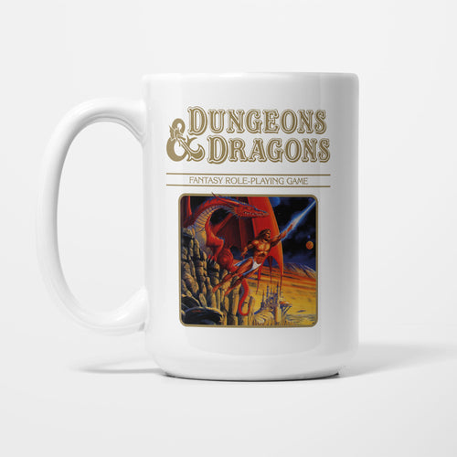 The 15oz Dungeons & Dragons Gold Box mug, white ceramic with the Dungeons & Dragons logo above vintage box artwork in a gold and orange colourway