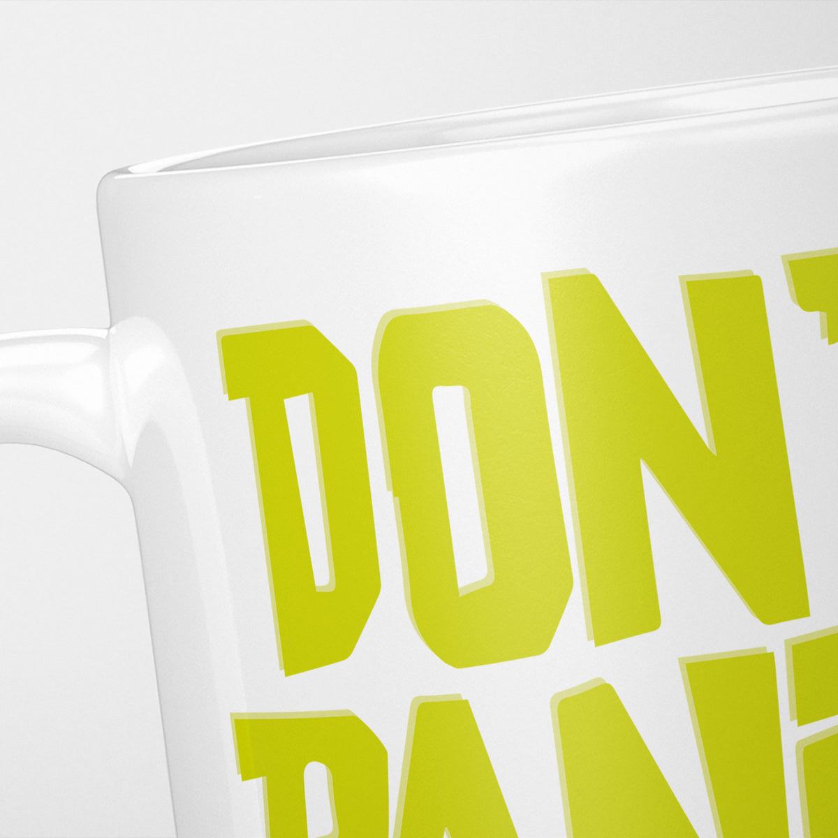 Close crop of the Don't Panic! mug, the yellow-green lettering filling the frame