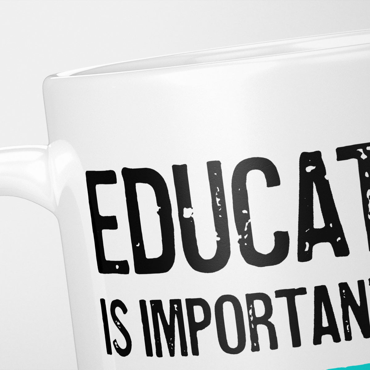 Close crop of the Education is Important mug, 'Educat…' above 'is importan…' in distressed black over a teal rule, with 'but Running is importanter' cropped out of frame