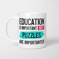 White ceramic mug with bold colourful text reading 'Education is Important but Puzzles are Importanter'