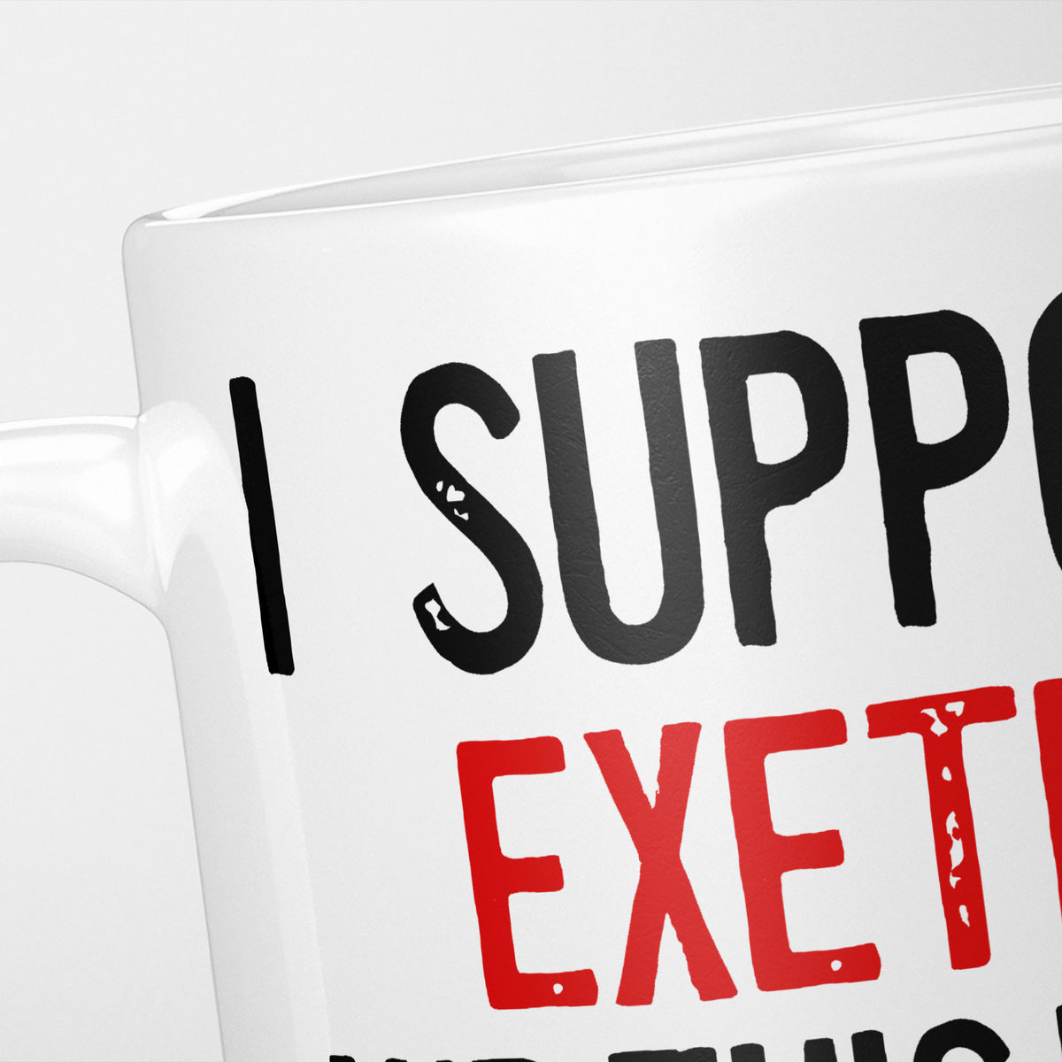 Close crop of the I Support Exeter mug, 'I Support' in heavy black above the club name in red, running off the edge of the frame