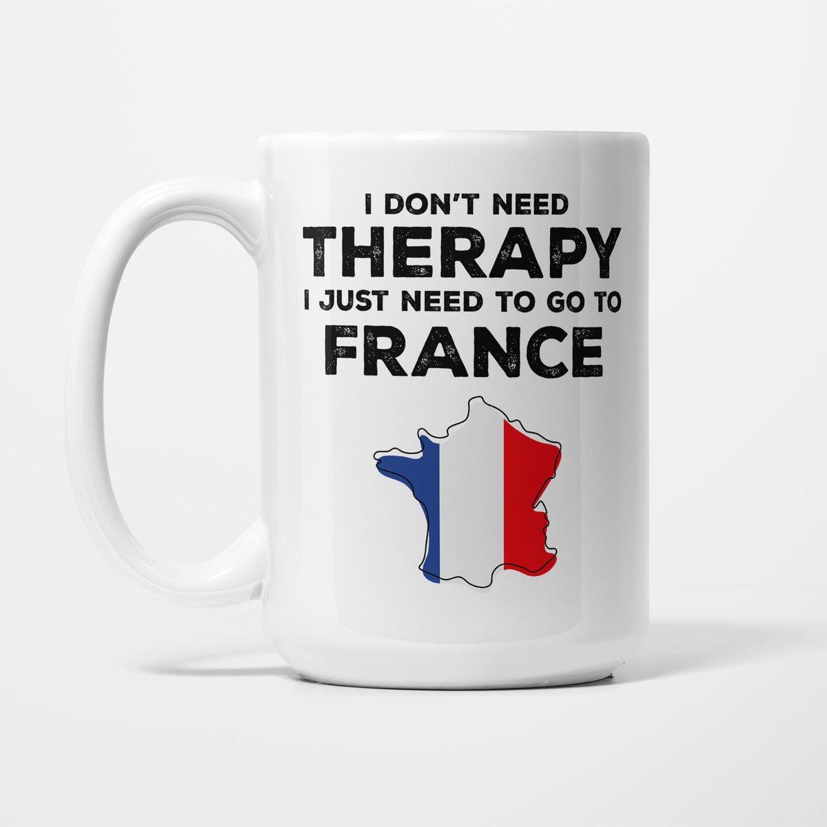 The 15oz I Need France mug, white ceramic in bold black type reading 'I don't need therapy, I just need to go to FRANCE', above an outline of France filled with its national flag