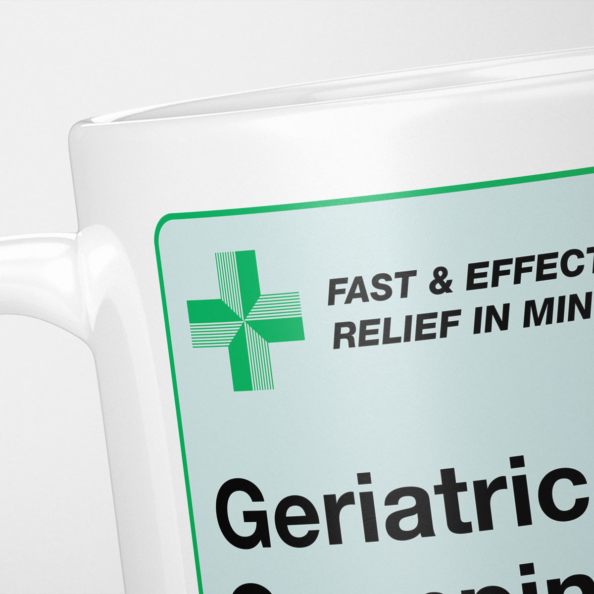 Close crop of the Geriatric Grumpiness Medication label, the green cross and 'fast and effective relief in minutes' above the name