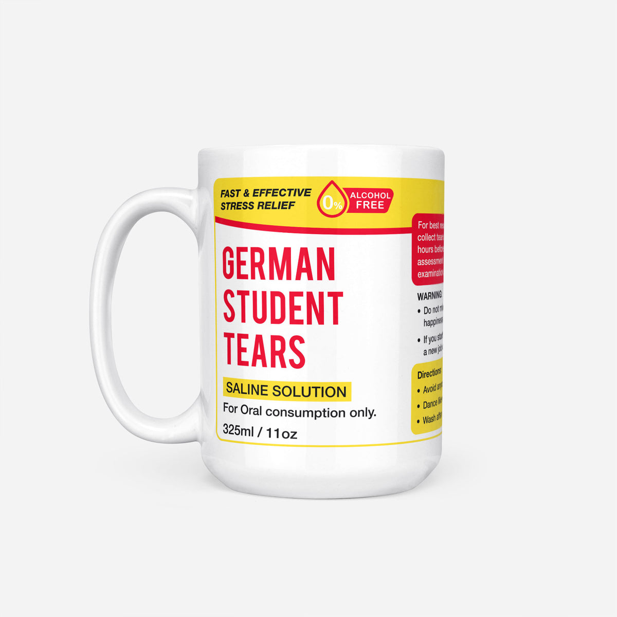 The 15oz German Student Tears mug, white ceramic with a yellow pharmacy-style label reading 'German Student Tears — Saline Solution, for oral consumption only'