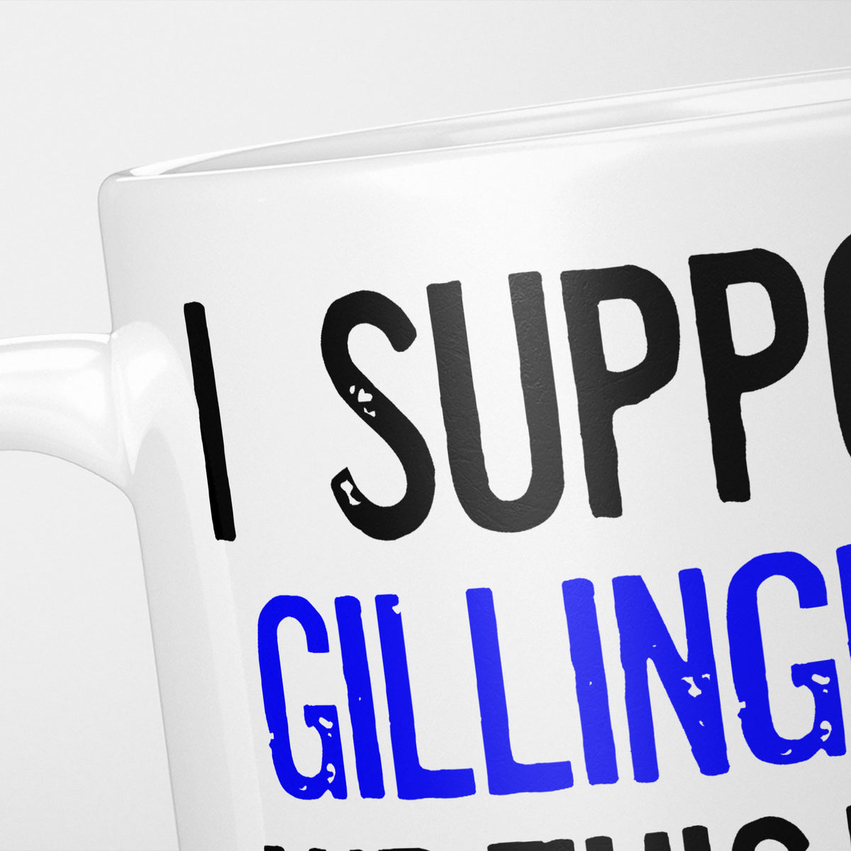 Close crop of the I Support Gillingham mug, 'I Support' in heavy black above the club name in blue, running off the edge of the frame