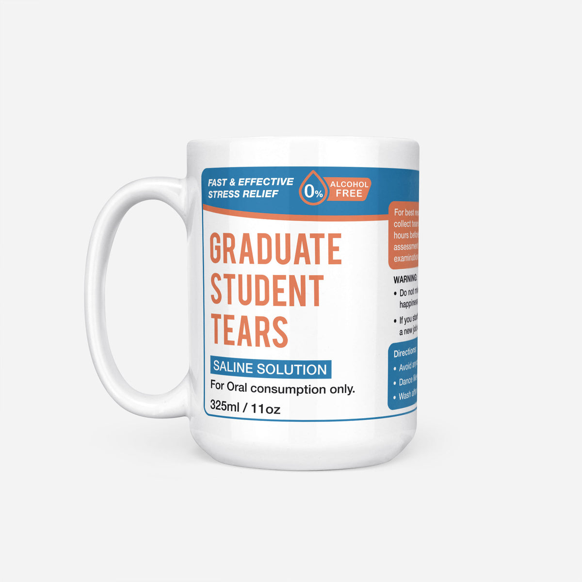 The 15oz Graduate Student Tears mug, white ceramic with a blue pharmacy-style label reading 'Graduate Student Tears — Saline Solution, for oral consumption only'