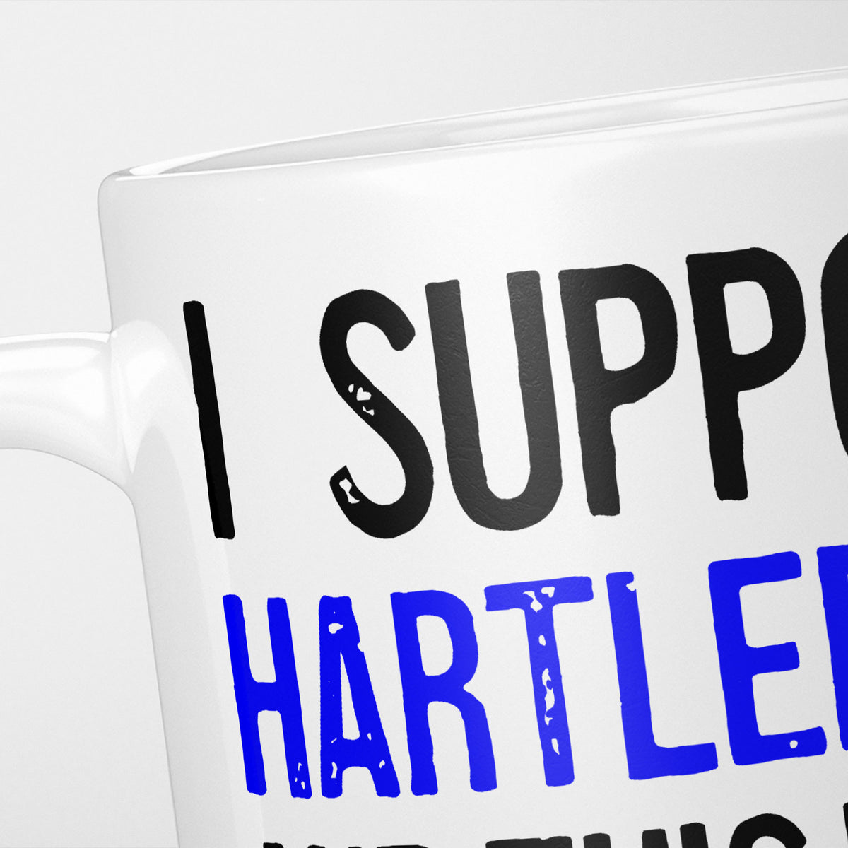 Close crop of the I Support Hartlepool mug, 'I Support' in heavy black above the club name in blue, running off the edge of the frame