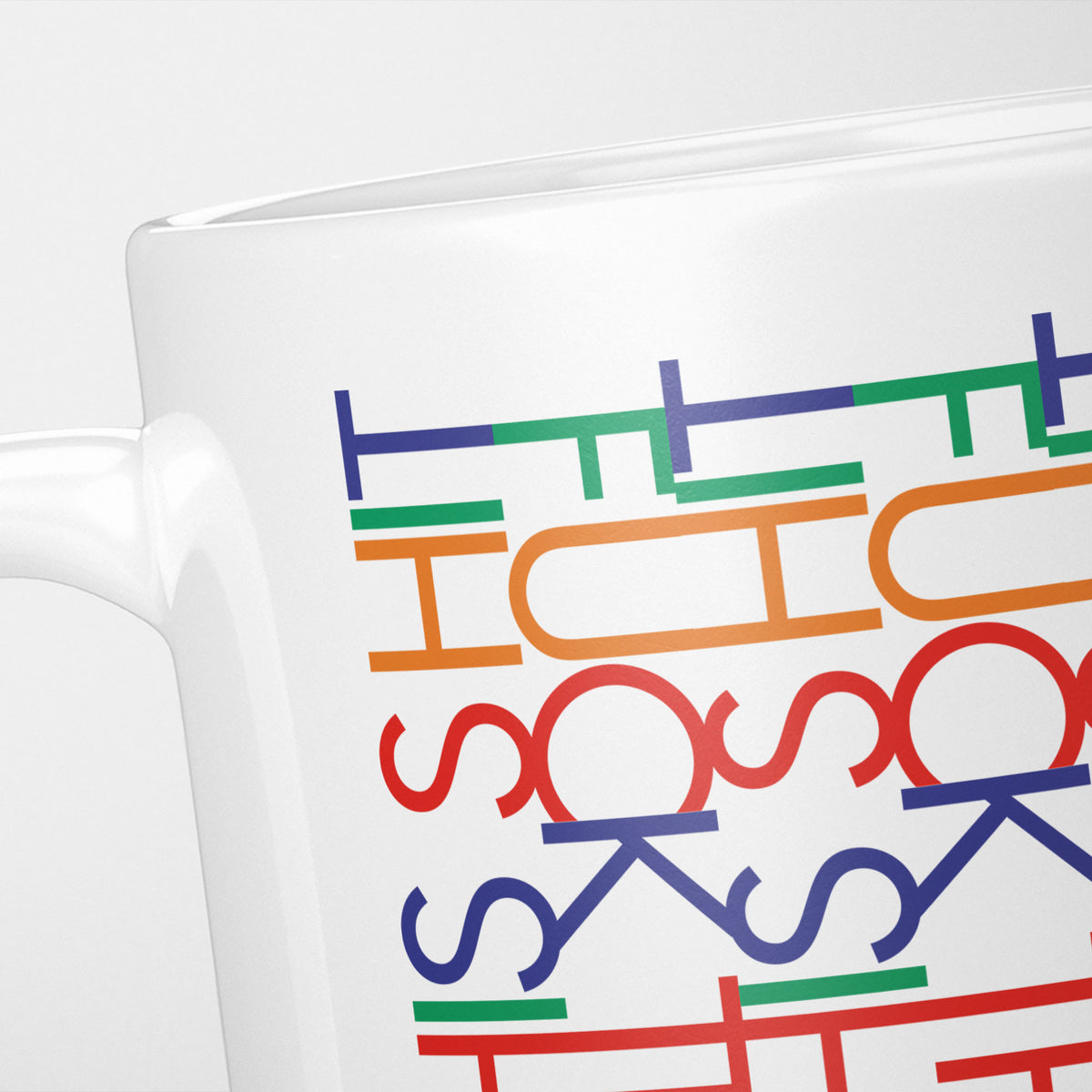 Close crop of the Funny Hidden Message "F*ck This Sh*t" mug, rows of blue, red, orange and green interlocking letterforms, tighter than they first appear