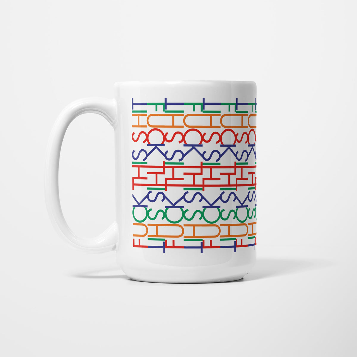 Left side of the 15oz Funny Hidden Message "F*ck This Sh*t" mug, white ceramic patterned with rows of interlocking letterforms in blue, red, orange and green that resolve into 'f*ck this sh*t' when read straight on