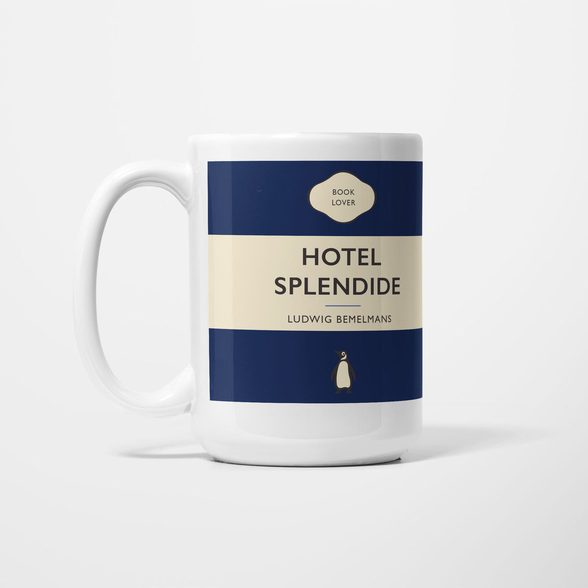 The 15oz Hotel Splendide mug, white ceramic printed as a vintage paperback jacket in navy and cream, reading 'Hotel Splendide' above Ludwig Bemelmans