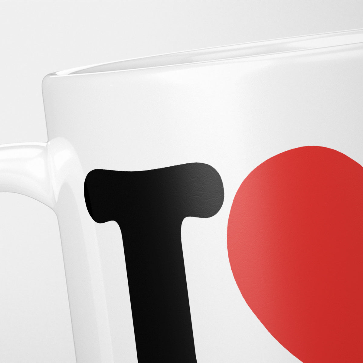 Close crop of the I Love Running mug, a heavy black 'I' beside a large red heart, with 'RUNNING' cropped out of frame below
