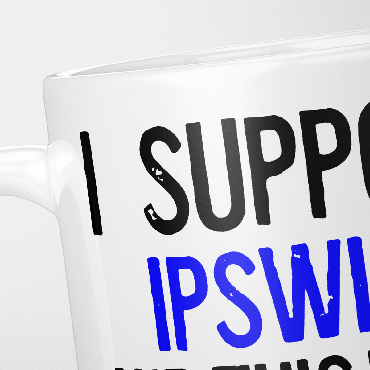 Close crop of the I Support Ipswich mug, 'I Support' in heavy black above the club name in blue, running off the edge of the frame