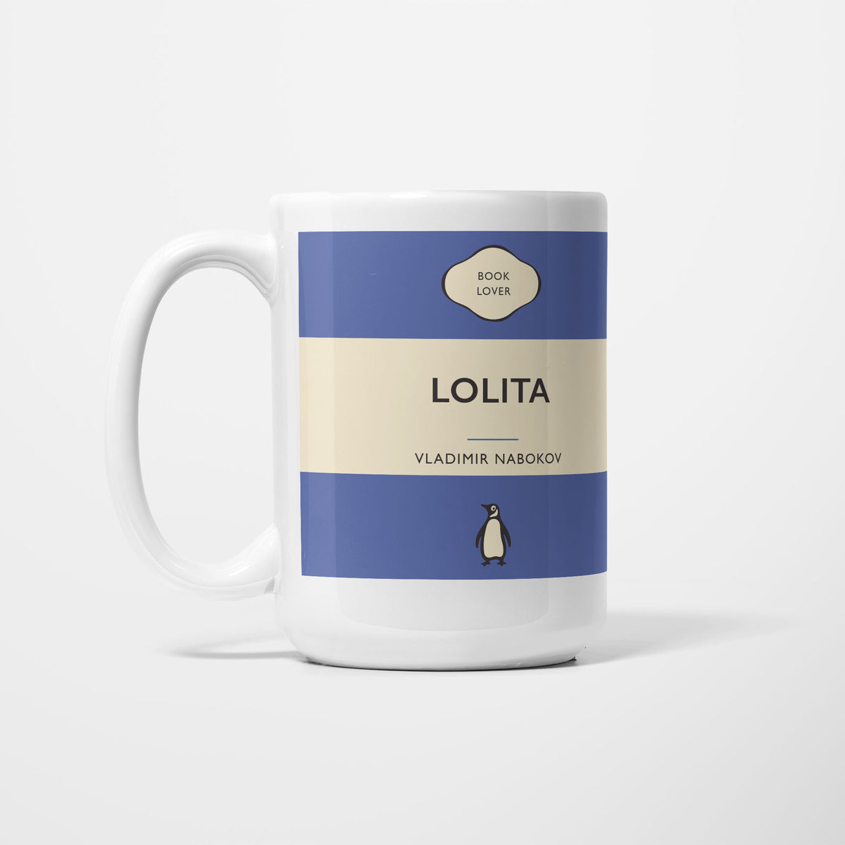 The 15oz Lolita mug, white ceramic printed as a vintage paperback jacket in blue and cream, reading 'Lolita' above Vladimir Nabokov