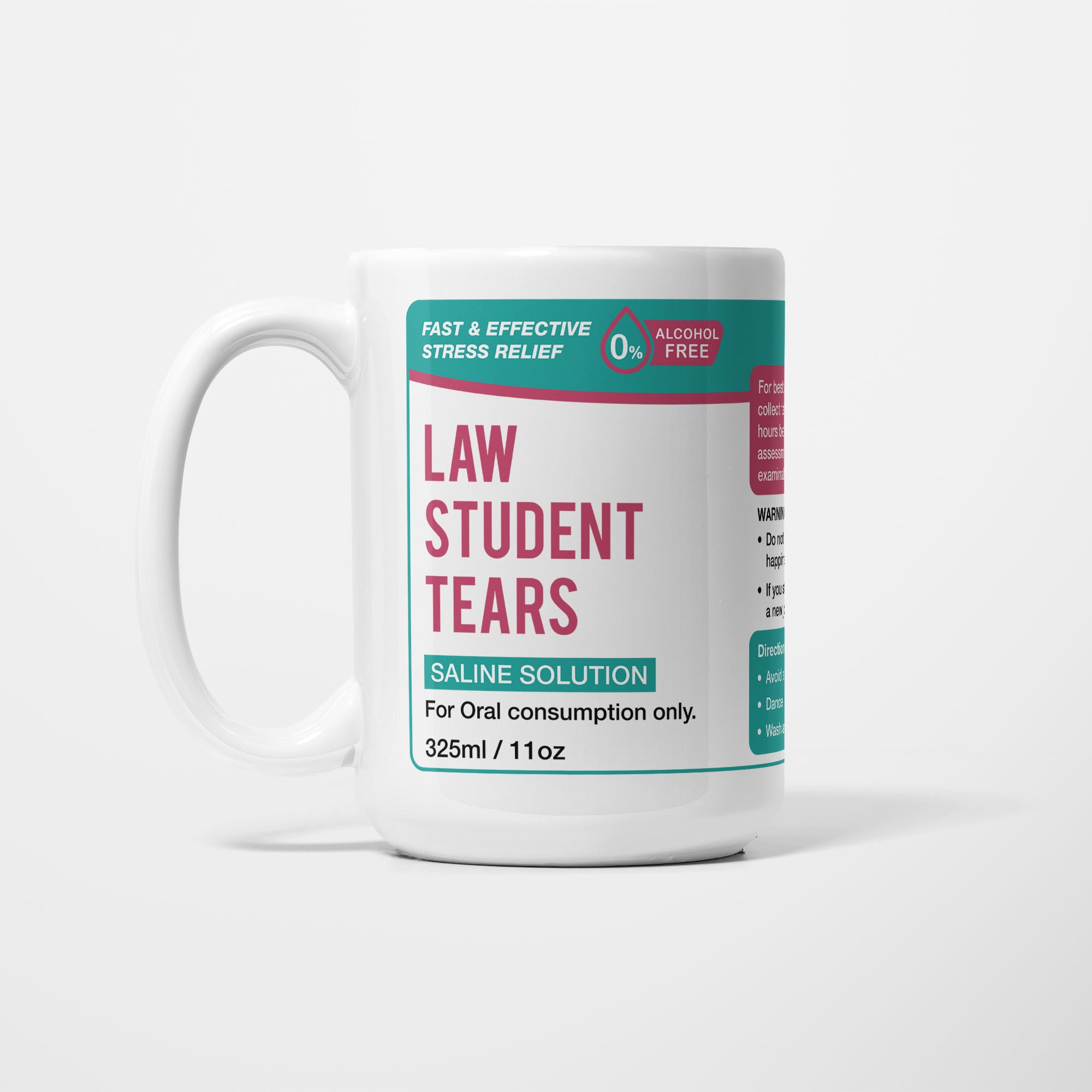 The 15oz Law Student Tears mug, white ceramic with a teal pharmacy-style label reading 'Law Student Tears — Saline Solution, for oral consumption only'