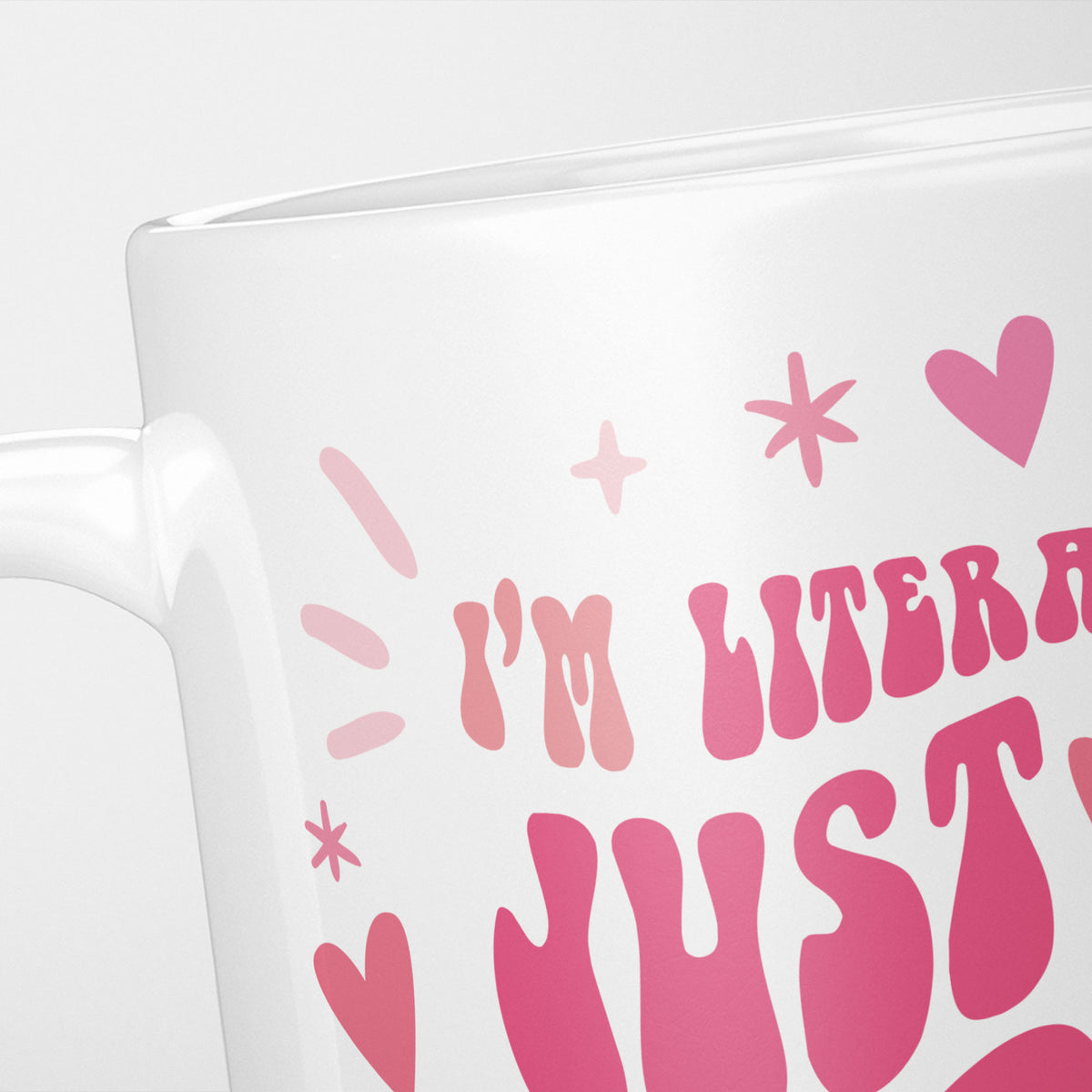 Close crop of the I'm Literally Just a Girl mug, pink retro lettering among hearts and sparkles