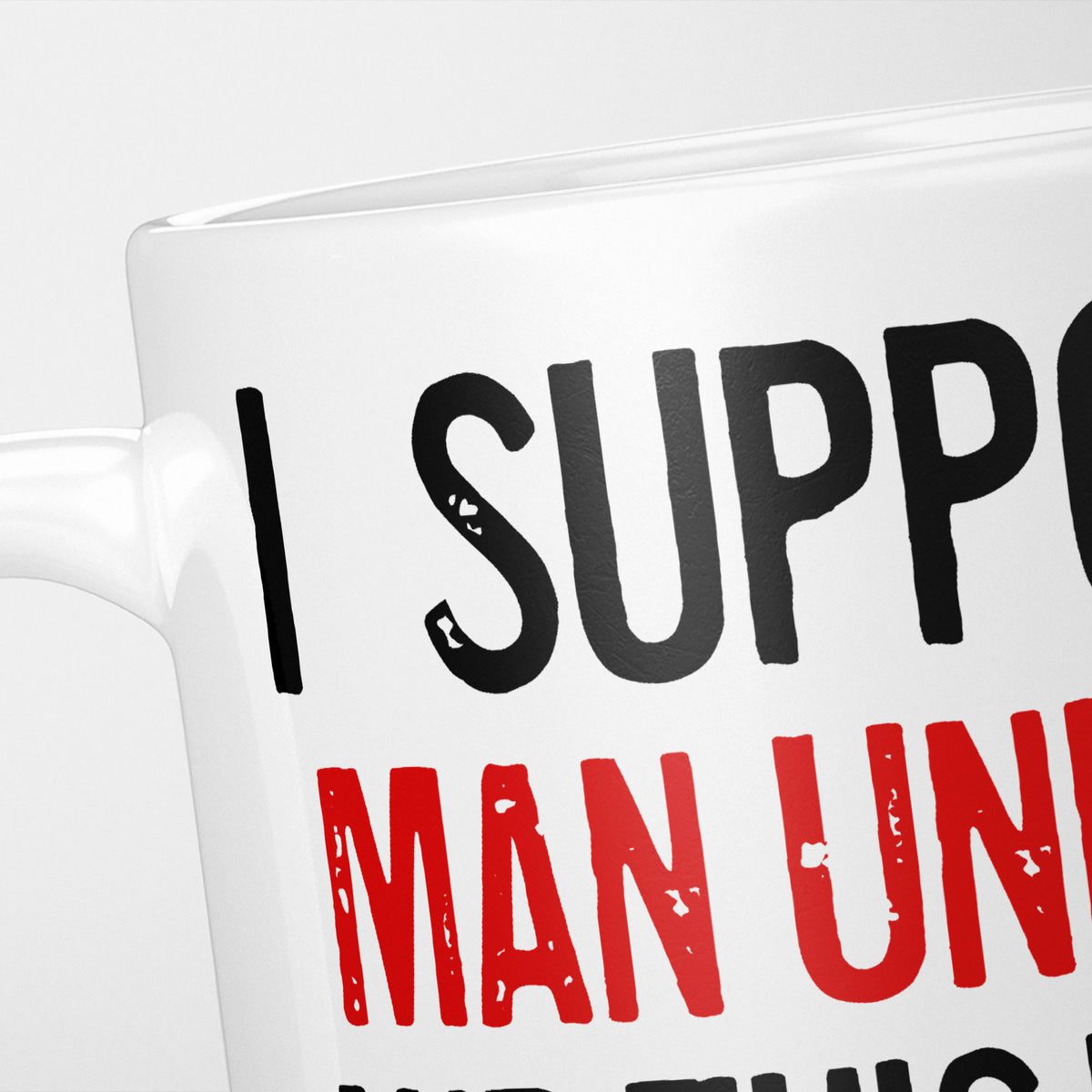 Close crop of the I Support Man United mug, 'I Support' in heavy black above the club name in red, running off the edge of the frame
