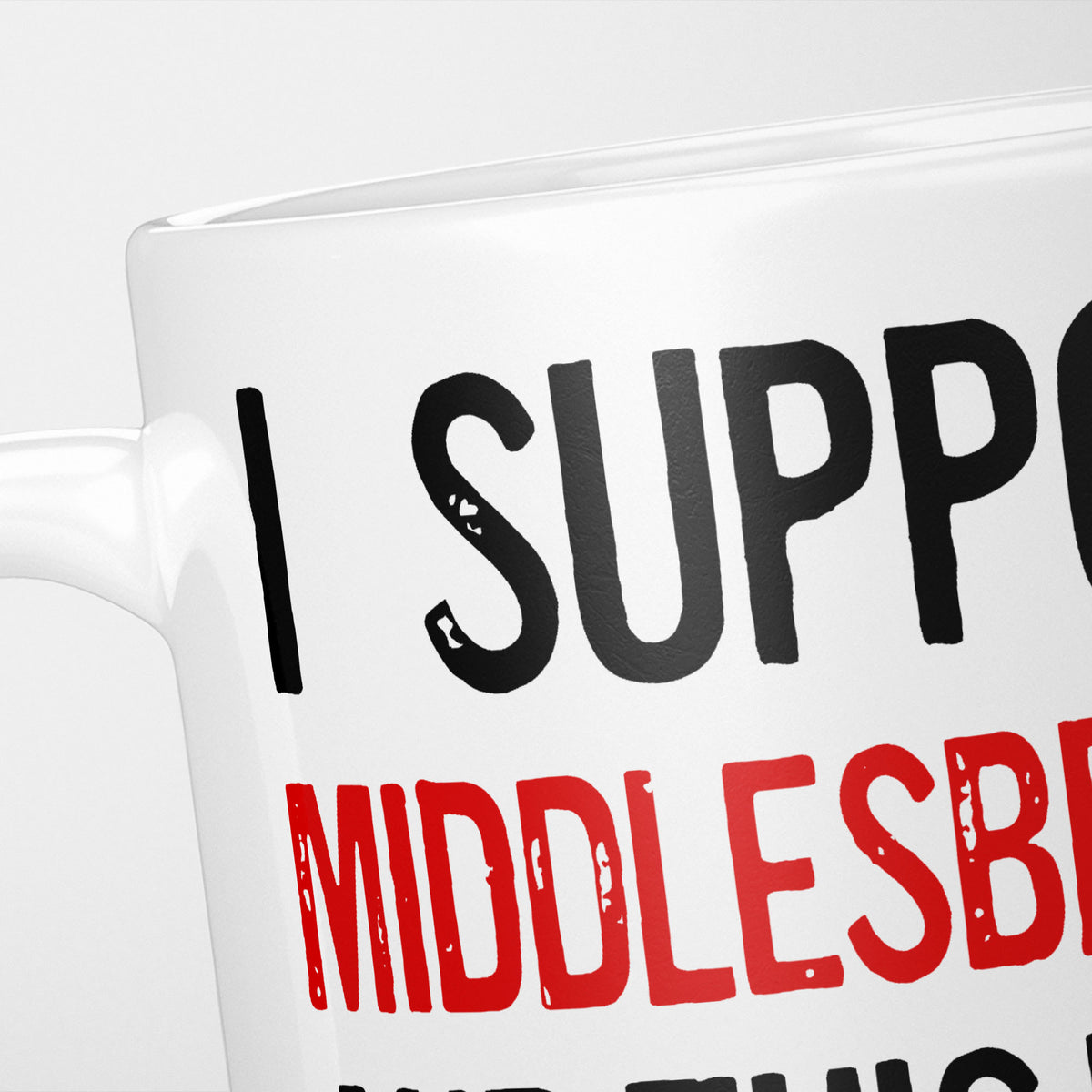 Close crop of the I Support Middlesbrough mug, 'I Support' in heavy black above the club name in red, running off the edge of the frame