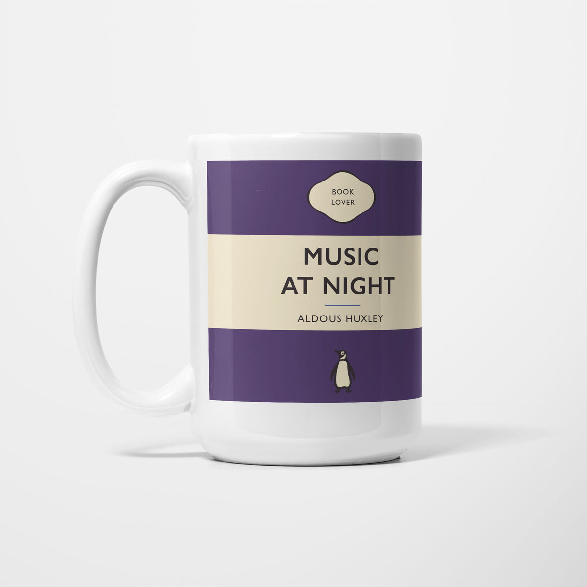 The 15oz Music at Night mug, white ceramic printed as a vintage paperback jacket in purple and cream, reading 'Music at Night' above Aldous Huxley