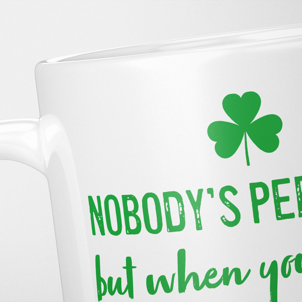 Close crop of the Nobody's Perfect Ireland mug, the green shamrock above 'Nobody's per…'