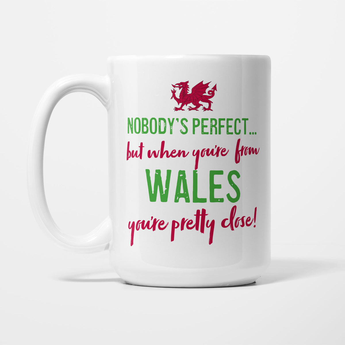 The 15oz Nobody's Perfect Wales mug, white ceramic reading 'Nobody's perfect... but when you're from WALES you're pretty close!' in red lettering beneath a red dragon