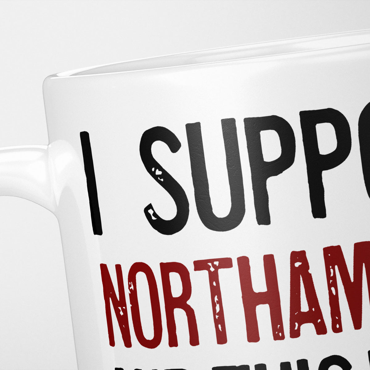 Close crop of the I Support Northampton mug, 'I Support' in heavy black above the club name in claret, running off the edge of the frame