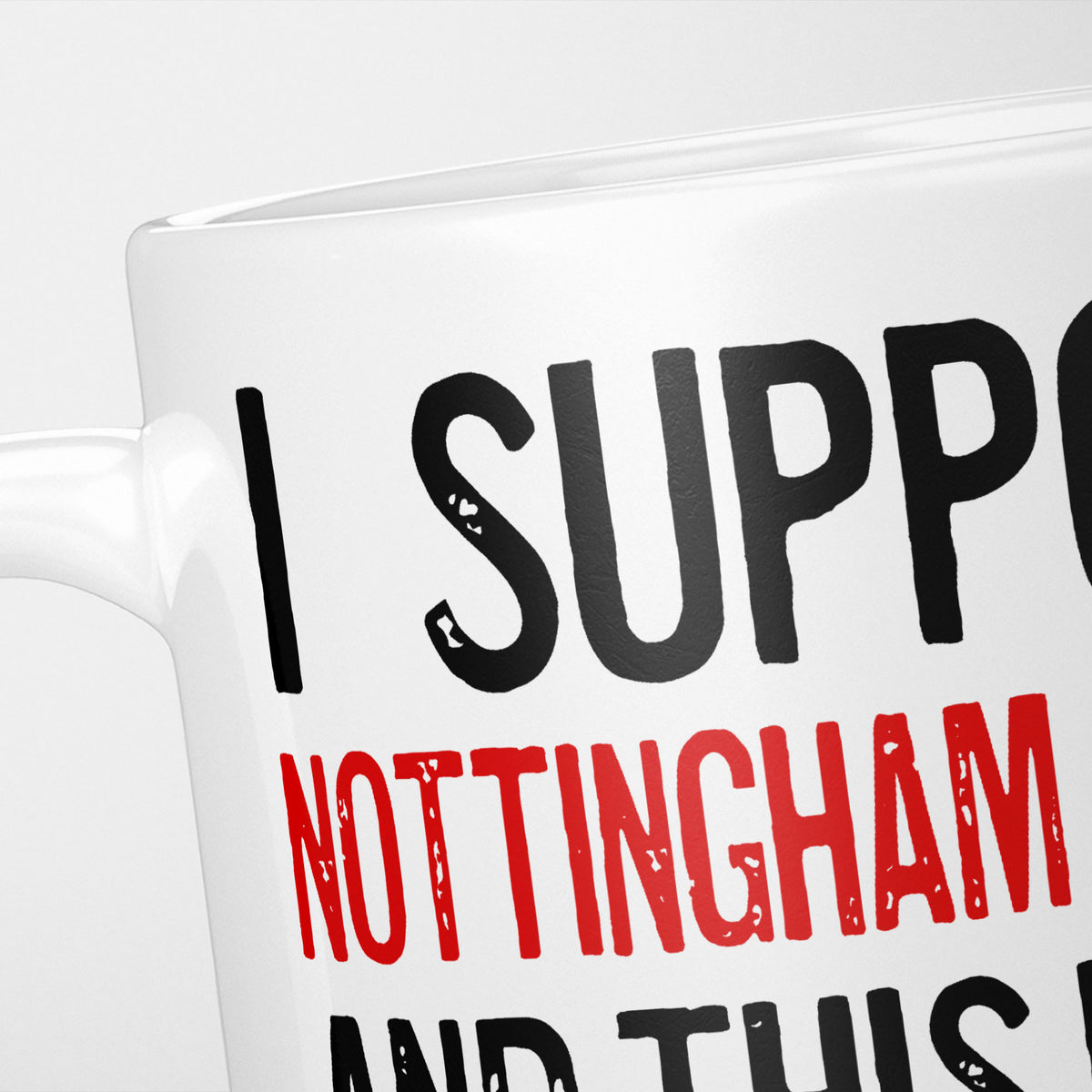 Close crop of the I Support Nottingham Forest mug, 'I Support' in heavy black above the club name in red, running off the edge of the frame