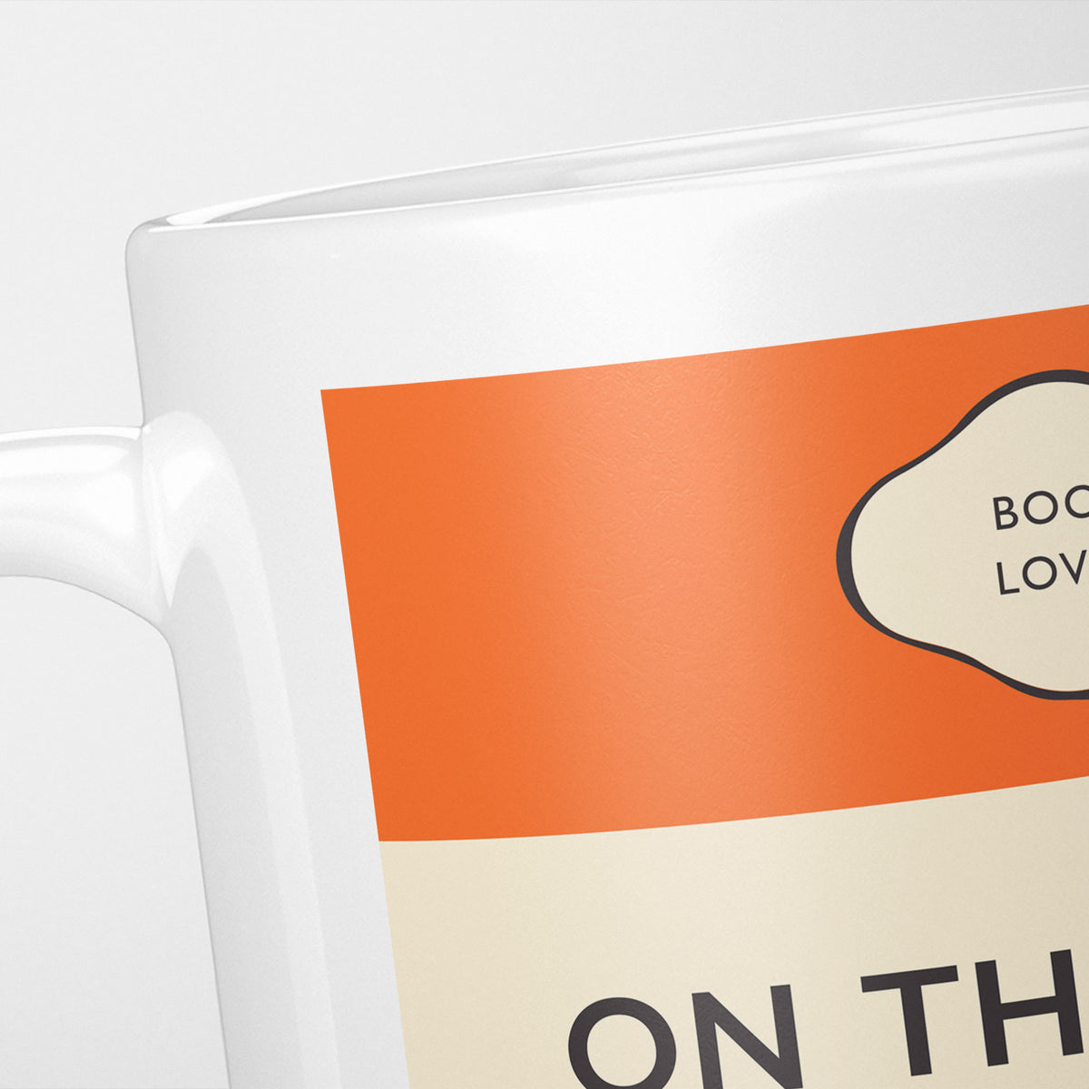 Close crop of the On the Road jacket, the orange band above the cream title panel, the lettering running off the frame