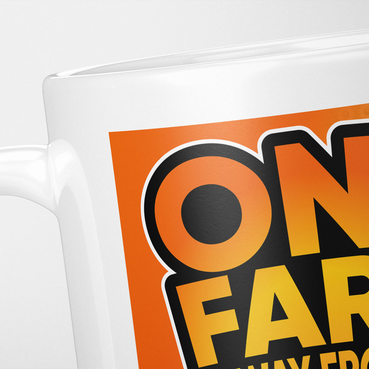 Close crop of the One Fart Away From A Poo mug, 'On… far…' in heavy black on orange