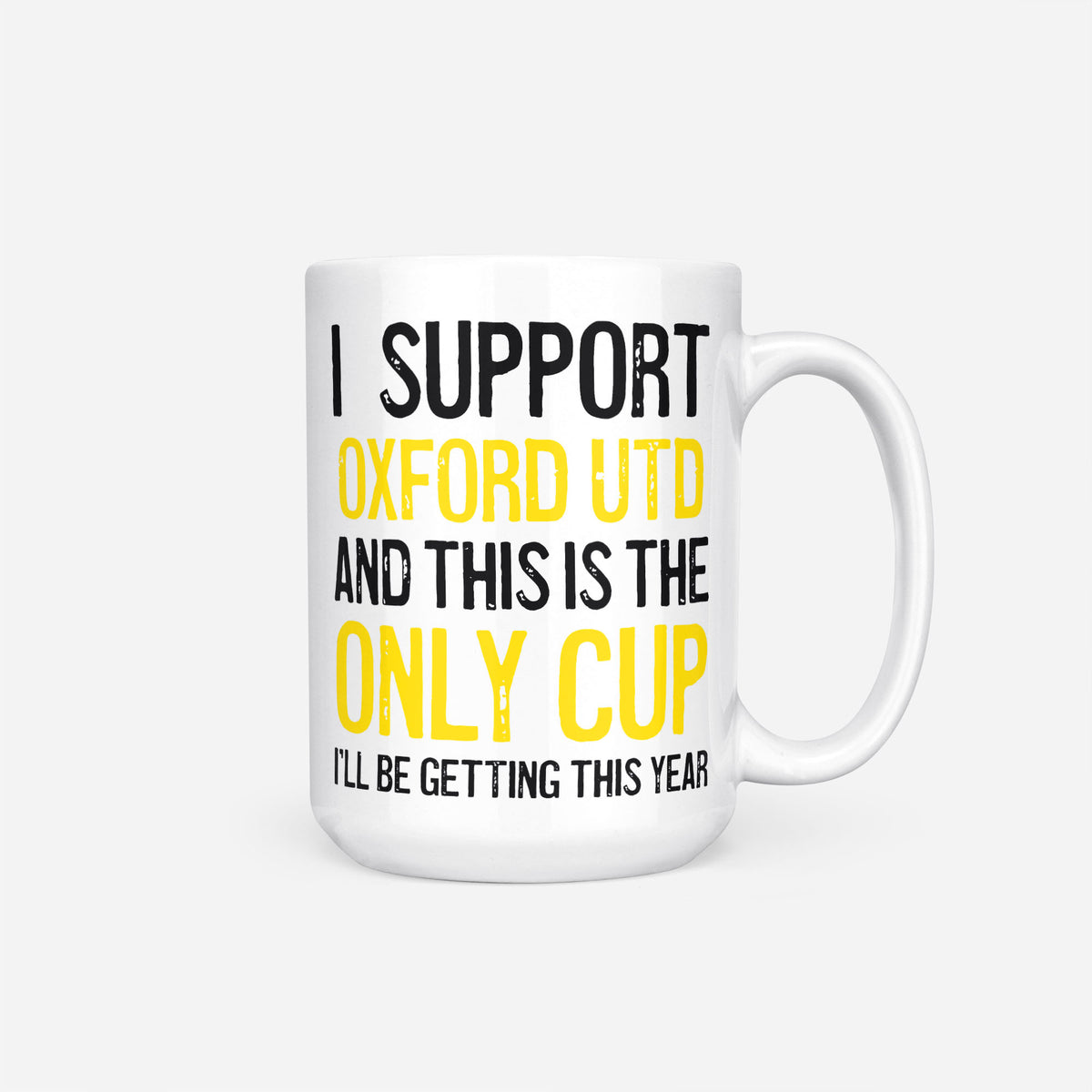 The 15oz I Support Oxford Utd mug, white ceramic reading 'I Support Oxford Utd and This is the Only Cup I'll Be Getting This Year', the club name and 'Only Cup' in yellow