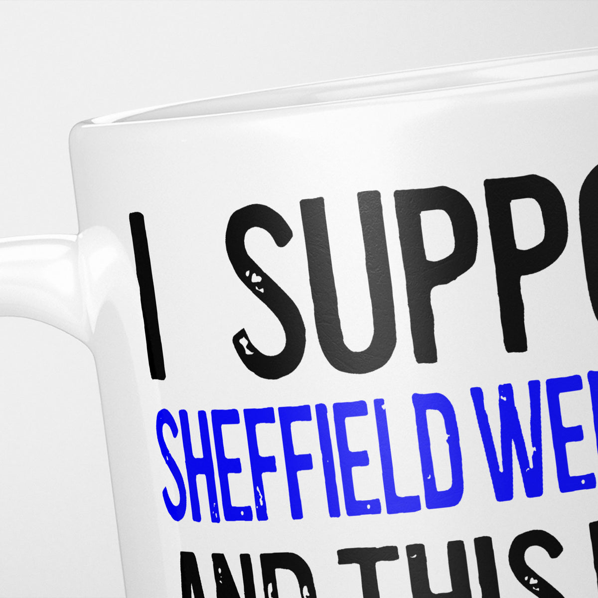 Close crop of the I Support Sheffield Wednesday mug, 'I Support' in heavy black above the club name in blue, running off the edge of the frame