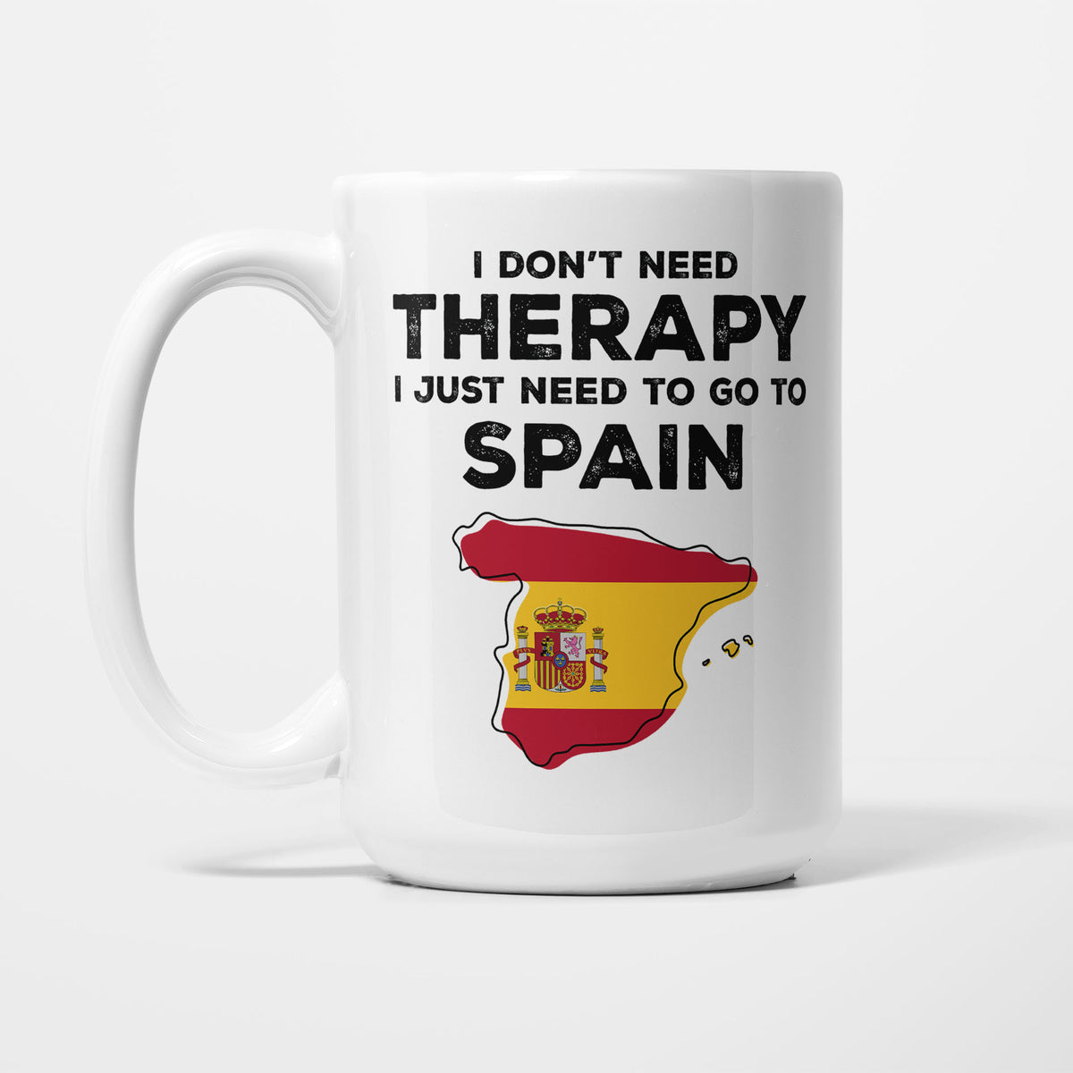 The 15oz I Need Spain mug, white ceramic in bold black type reading 'I don't need therapy, I just need to go to SPAIN', above an outline of Spain filled with its national flag