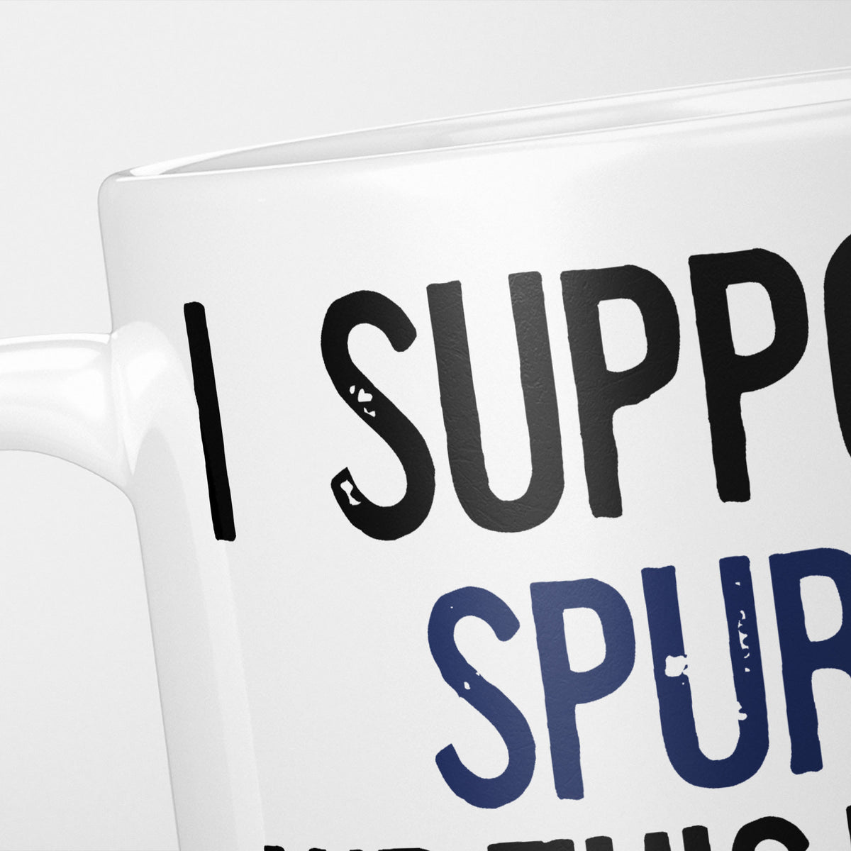 Close crop of the I Support Spurs mug, 'I Support' in heavy black above the club name in navy, running off the edge of the frame