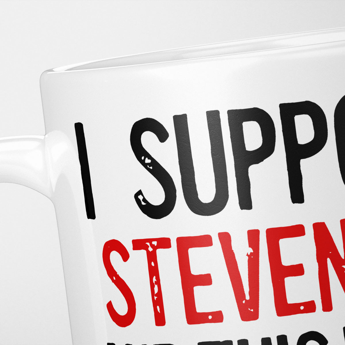 Close crop of the I Support Stevenage mug, 'I Support' in heavy black above the club name in red, running off the edge of the frame