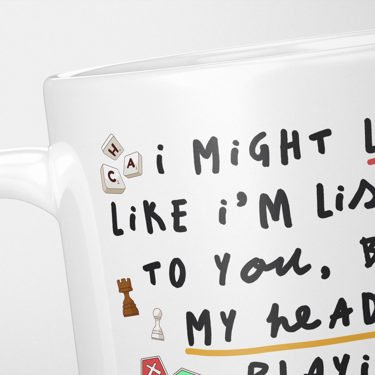 Close crop of the I'm Playing Board Games mug, handwritten doodle lettering with a knight, a pawn and lettered tiles